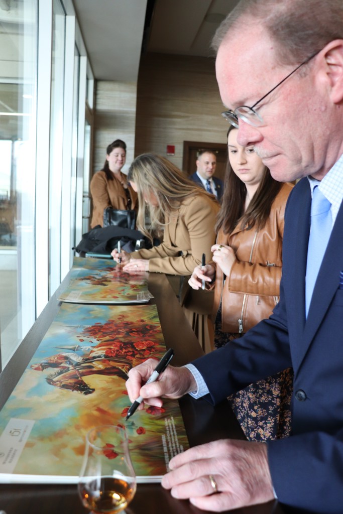 chris morris signing a print of the art