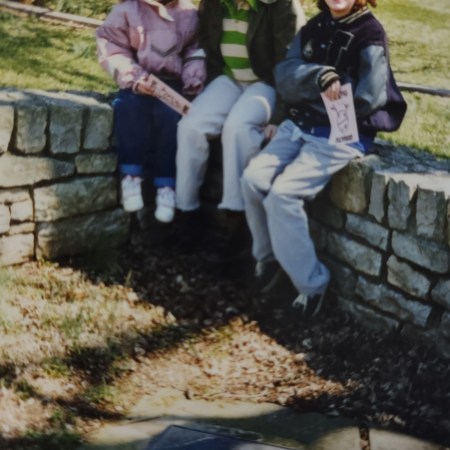 just three kids sitting in a cemetery